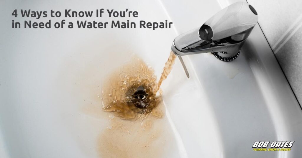 Brown, rusty water pouring from a bathroom faucet into a white sink, indicating possible water main damage.