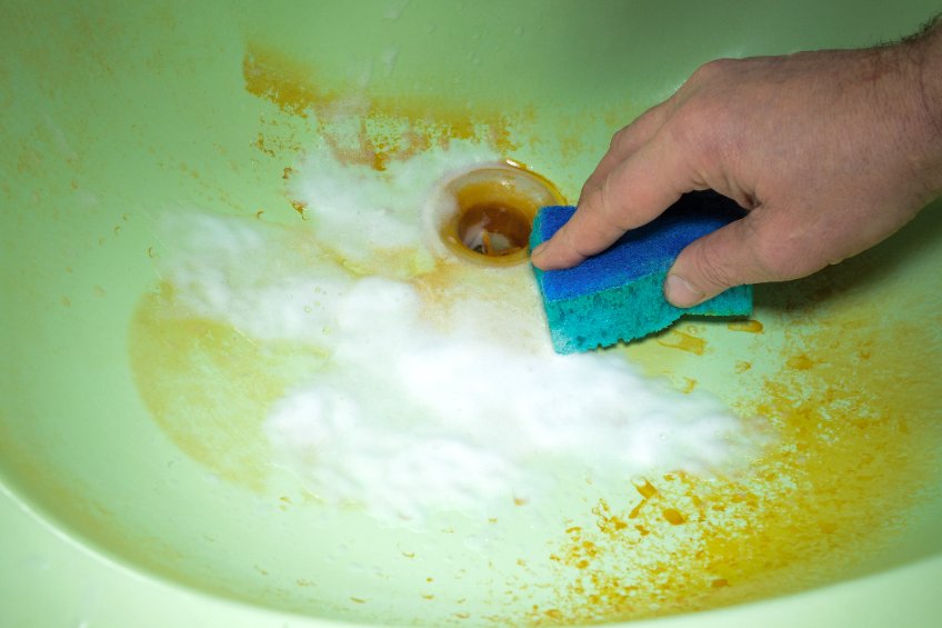 Close up of scrubbing a dirty sink