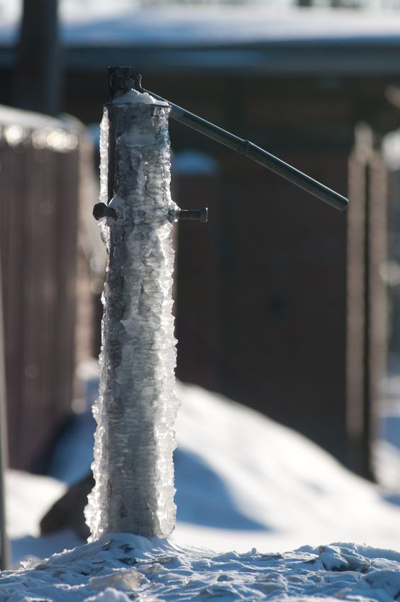 Frozen water-tap on mound of icy surdace