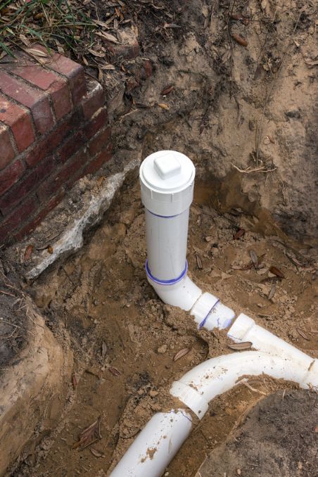 New sewer pipe installed, visible in dug out outdoor trench