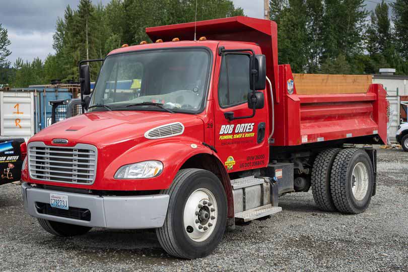 Dump truck with Bob Oates logo on it