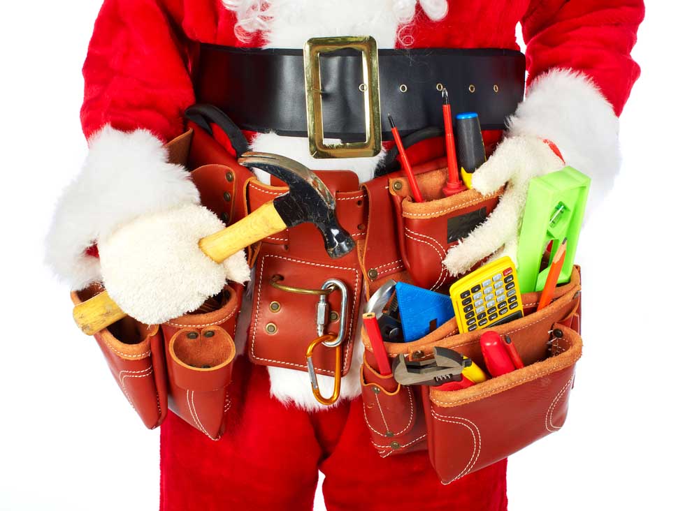 Santa Worker with a tool belt over white background.