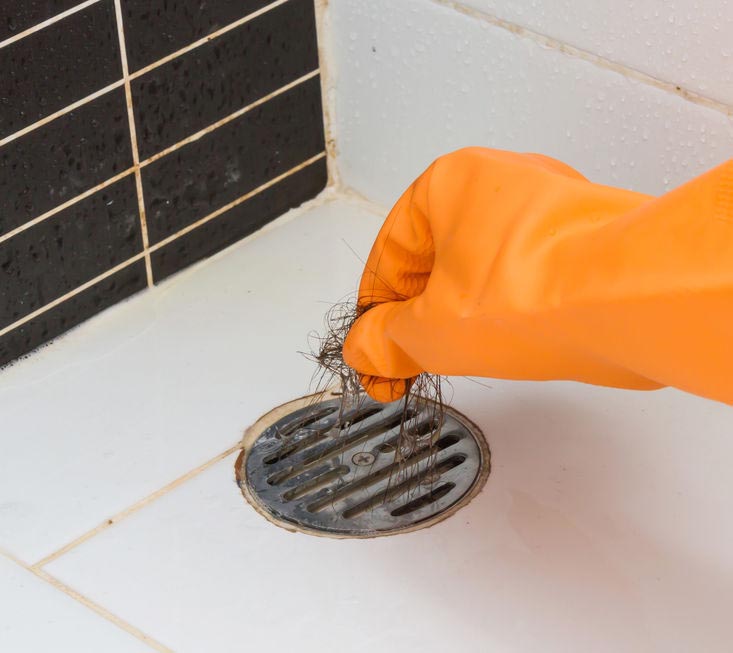 Cleaning bathroom drain clogged with hair