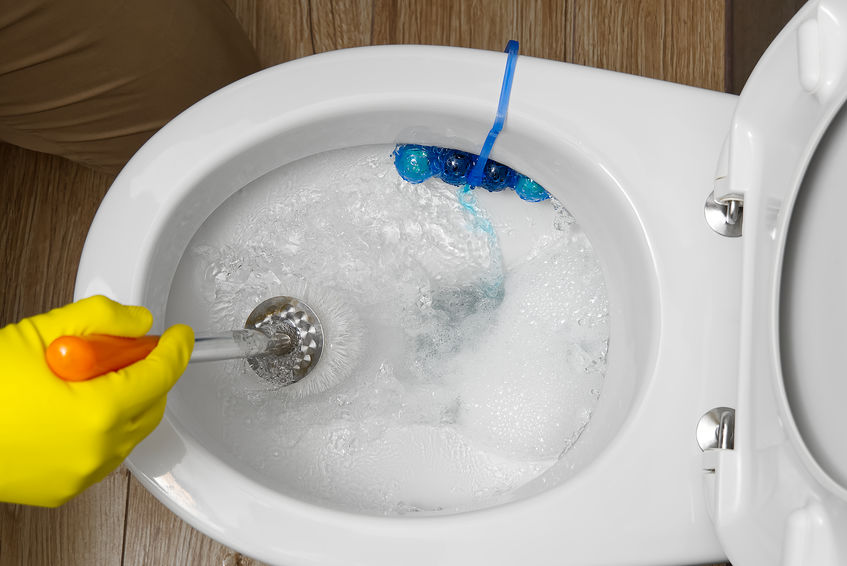 Person scrubbing toilet that is flushing properly