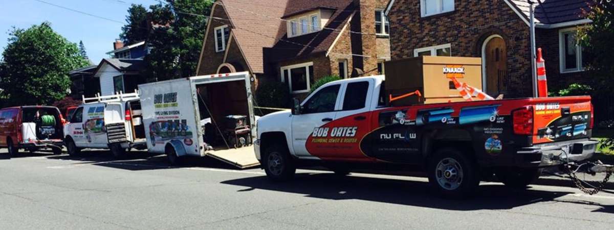 Bob Oates work vehicles on residential street