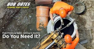Two technicians working with high pressure water jetter