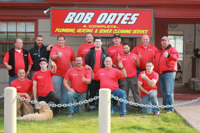 Group picture of 20 members of the Bob Oates team in front of company office