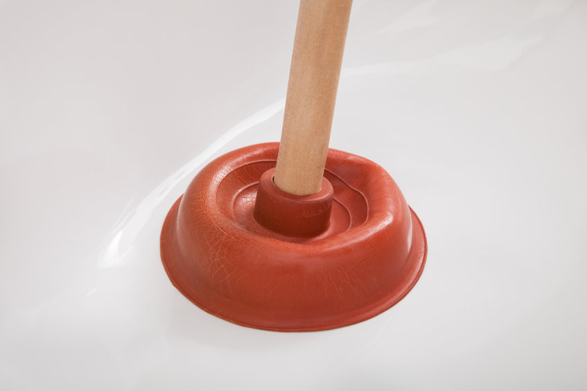 Plunger being pressed into drain