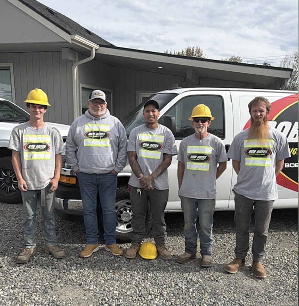 Bob Oates underground crew standing with General Manager John Peterson in front of a company service van outside the Bob Oates shop in Pacific, WA.