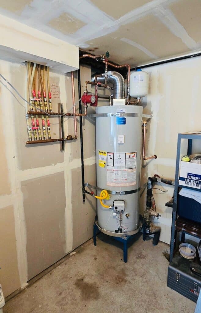 Bob Oates Plumbing technician installed a tank water heater in a Seattle home utility room.