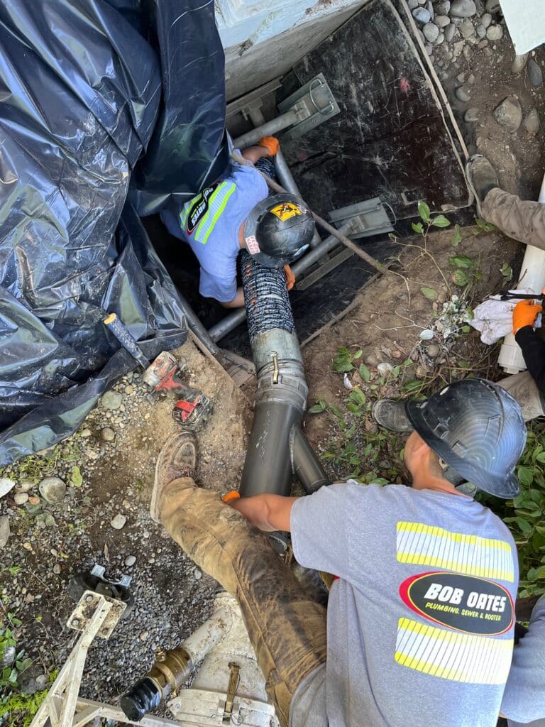 Bob Oates crew finishing a trenchless sewer cleanout and cured-in-place-pipe lining installation.