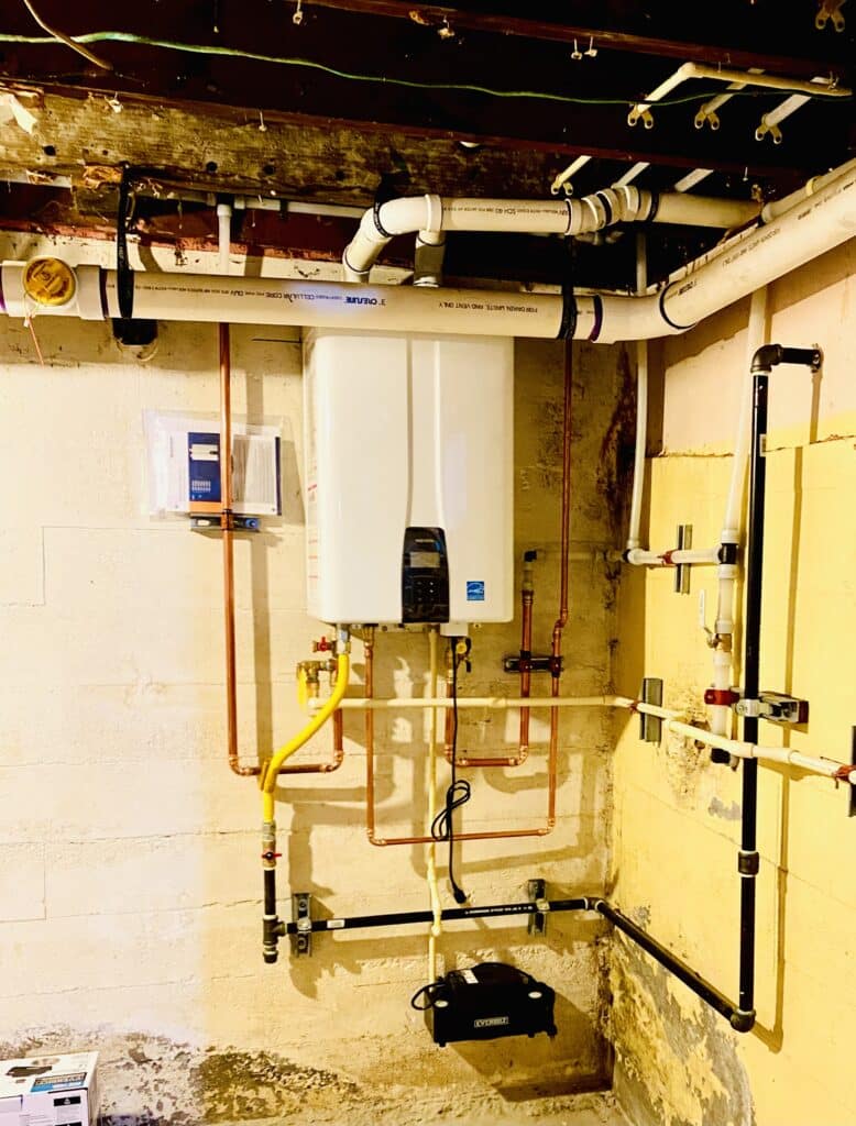 Tankless water heater installed by Bob Oates Plumbing technicians in a Seattle basement.