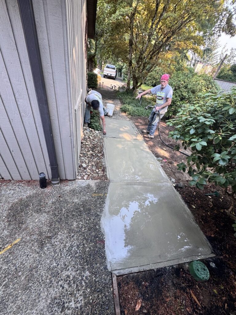 New concrete walkway after underground sewer line replacement and cleanout installation