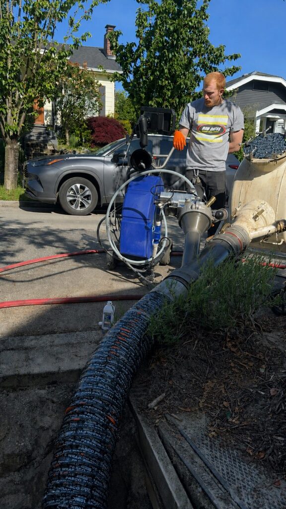 Bob Oates technician setting up equipment for CIPP sewer liner installation and blue light curing