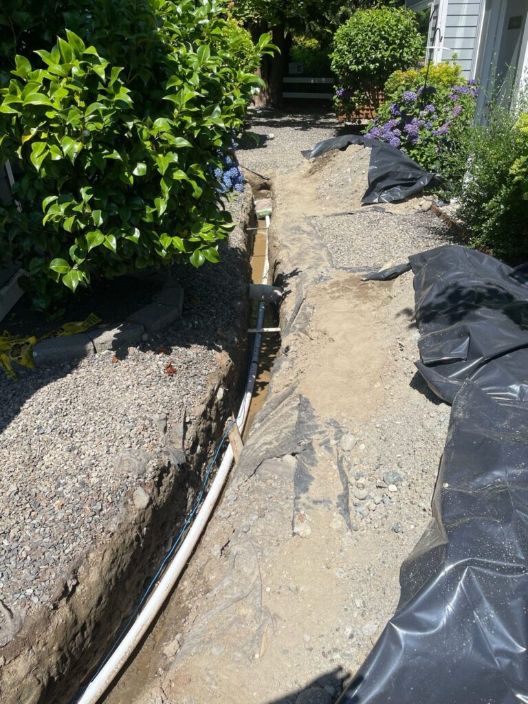 Residential water line replacement trench running through a Seattle property