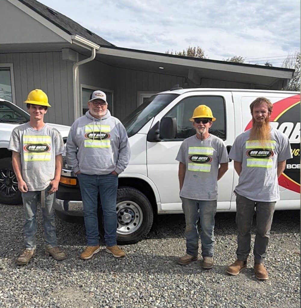 Bob Oates underground crew standing with General Manager John Peterson in front of a company service van outside the Bob Oates shop in Pacific, WA.