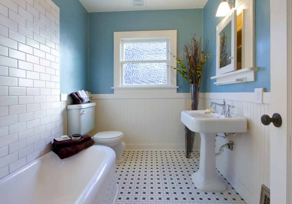 Clean bathroom with low-flow toilet, pedestal sink, and water-efficient fixtures