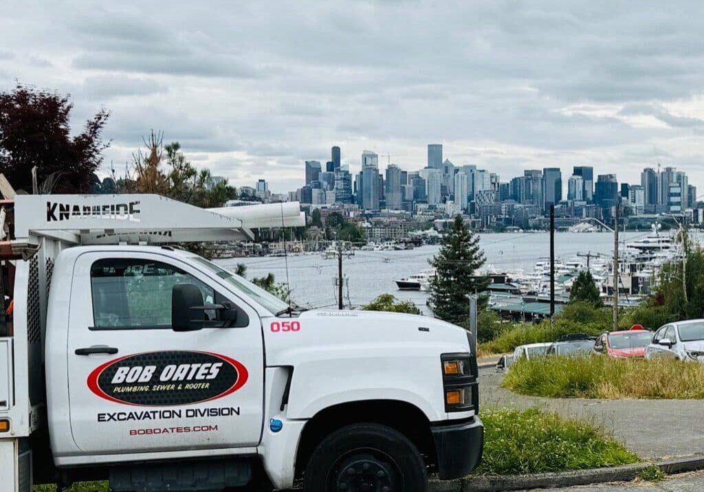 Bob Oates work truck parked near Lake Union with Seattle skyline in the background.