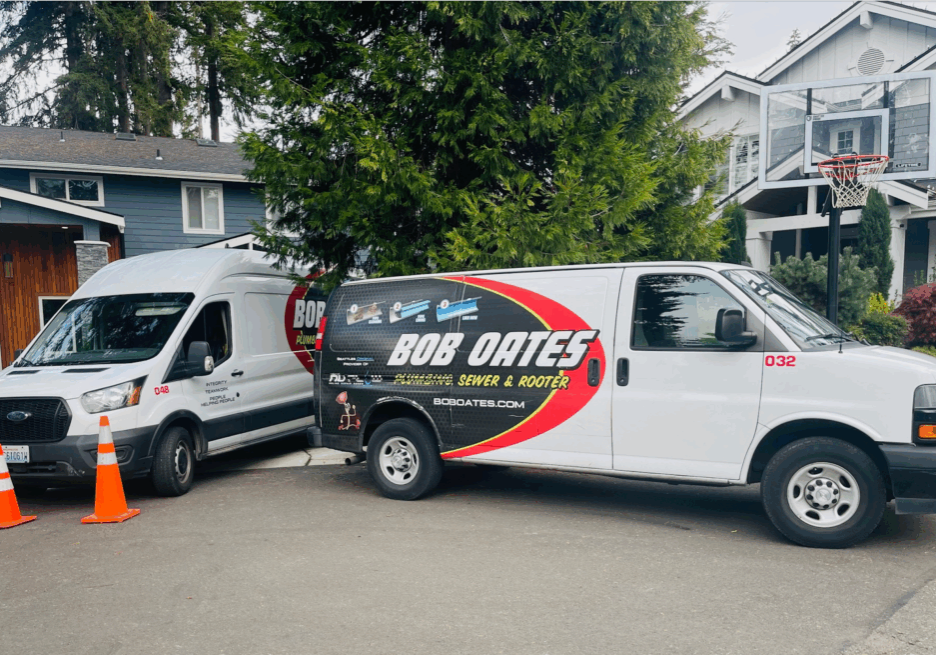 Bob Oates Plumbing, Sewer & Rooter trucks parked at a residential service call in Seattle