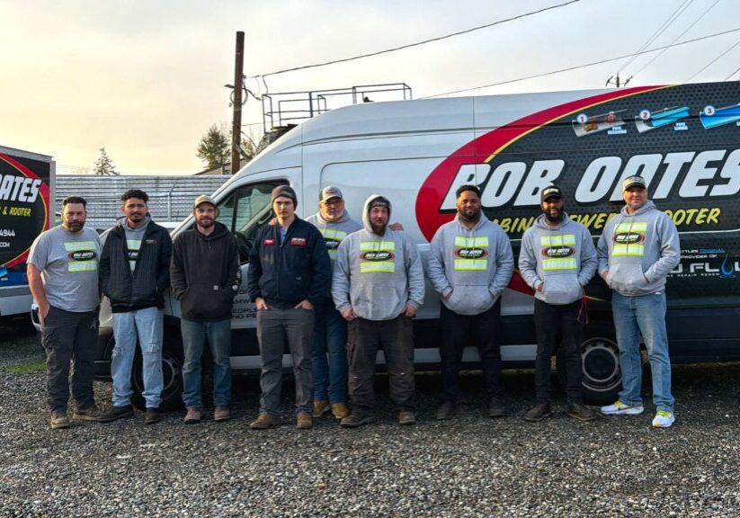 Bob Oates Plumbing, Sewer & Rooter team standing in front of a service van in Seattle