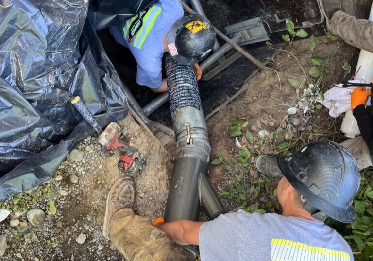 Bob Oates crew finishing a trenchless sewer cleanout and cured-in-place-pipe lining installation.